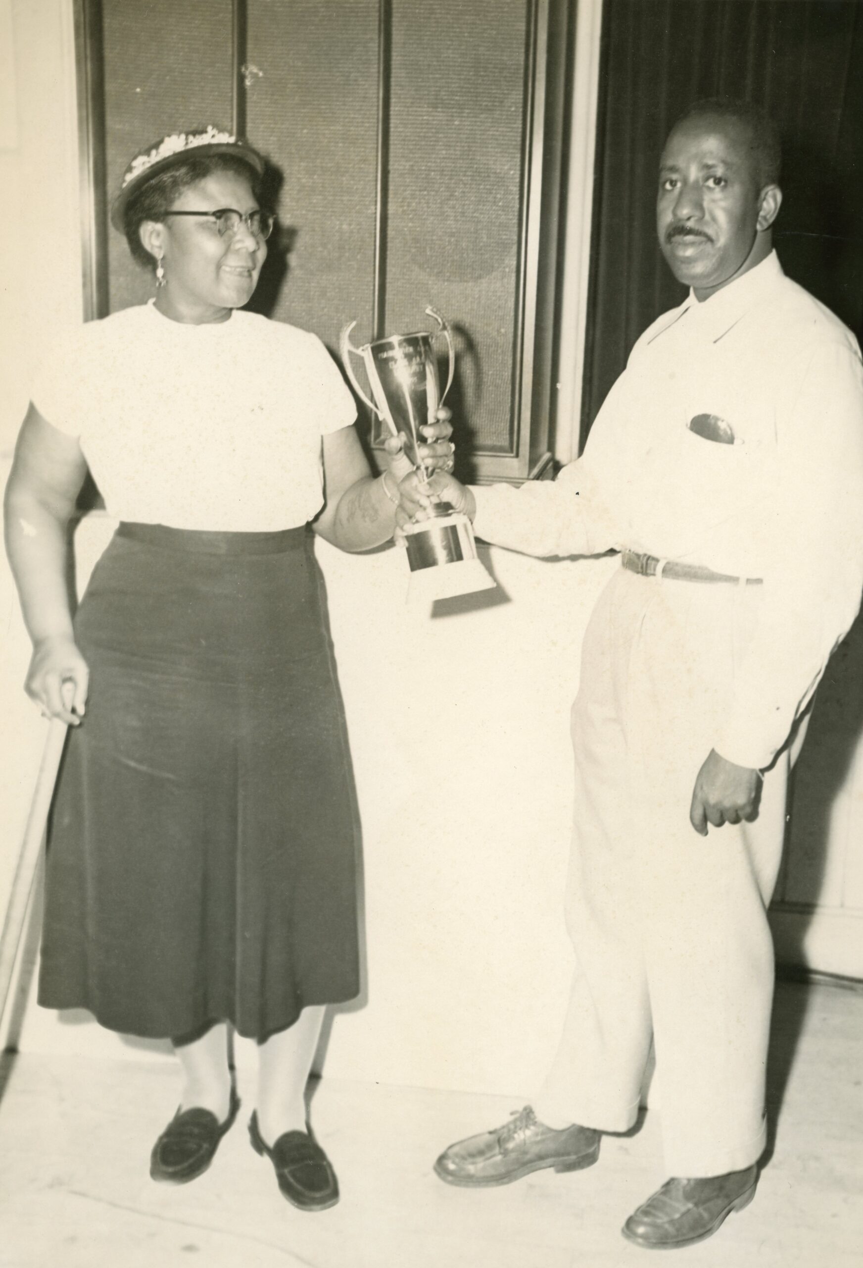 Dr. George Ruble Woolfolk delivering a much deserved reward in the 1950s