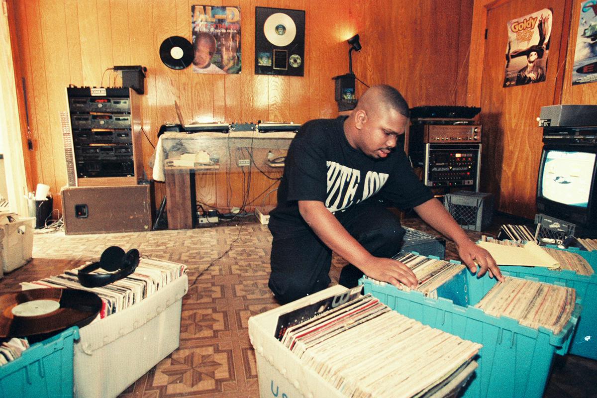 DJ Screw shifting through records.
