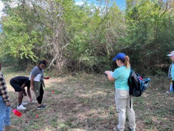 Nesta Anderson documenting unmarked graves with PVAMU students [Photo © T. DeWayne Moore, 2023]