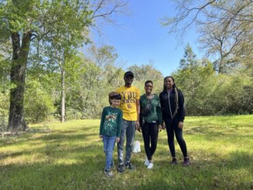 Dr. Moore's son, Noah, surveys the cemetery with students workers on the Digital PV Panther Project--Noah Jackson, Zynitra Durham, and Jaylynn Brantley