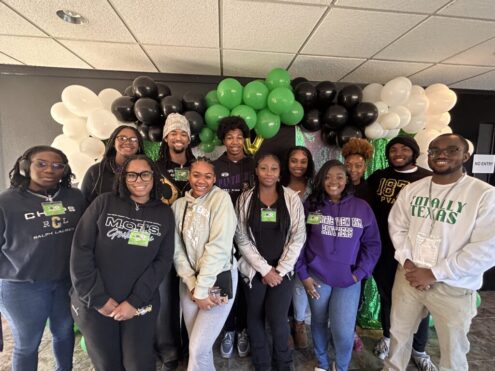 A group of Prairie View students posing together for a picture during a community service commute .