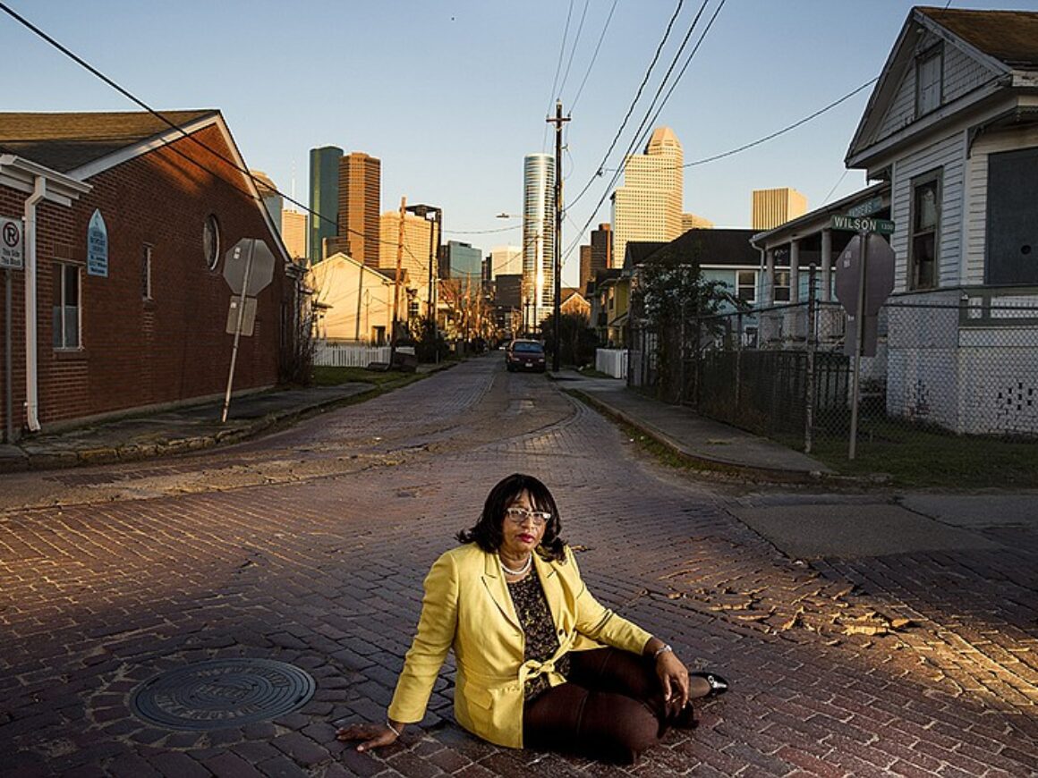 Woman sitting in the middle of the street in Houston, Texas.