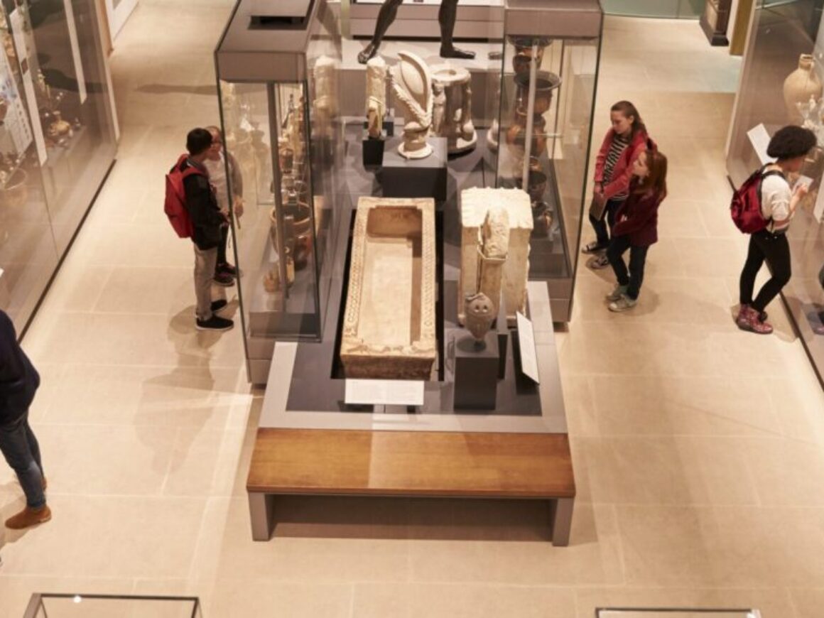 Men and women examining museum exhibits