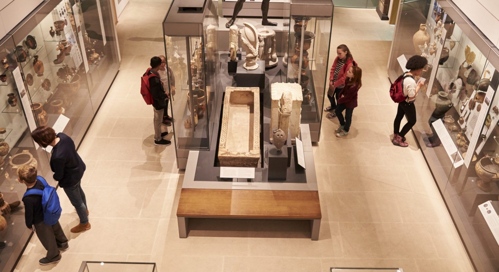 People examining exhibits at an unidentified museum [Photographer Unknown, 2021?] Who is McCarthy?