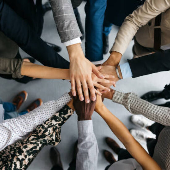 Close-up of co-workers stacking their hands together stock photo Getty Images