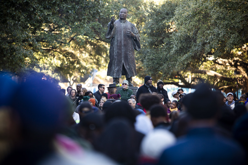 People gather around the Martin Luther King Jr. statue on UT Austin's campus on MLK Day in January 2020.